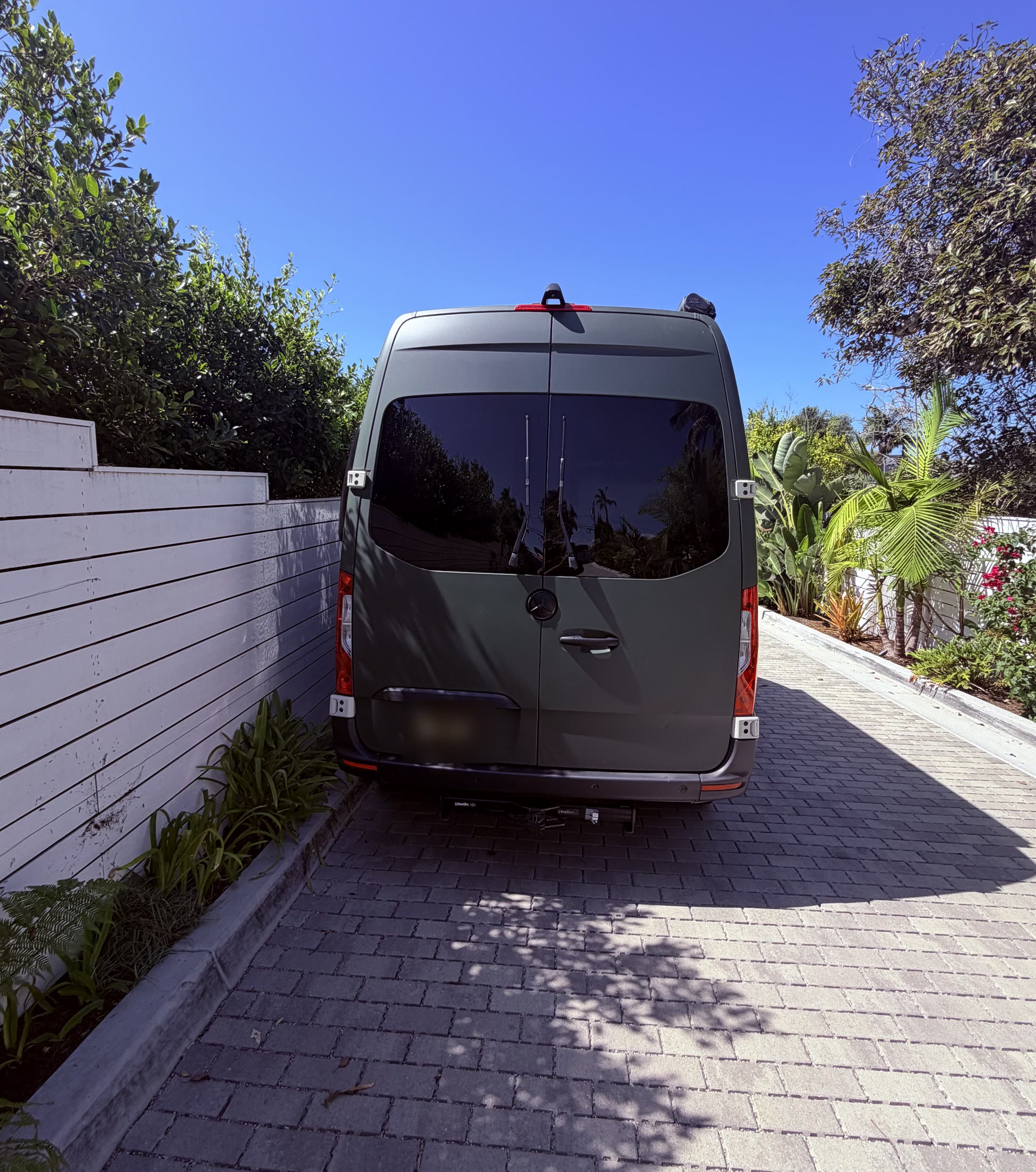 Rear exterior of matte green Sprinter camper